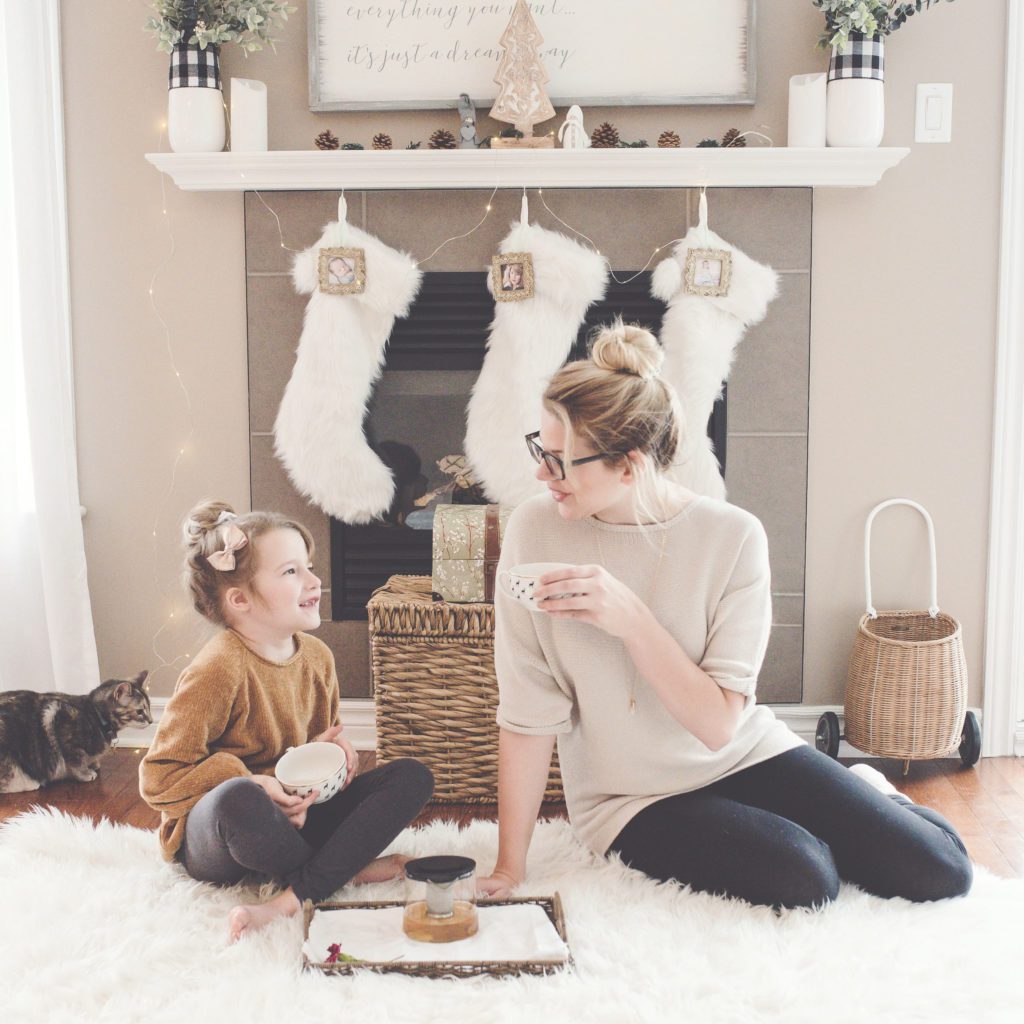 Mom and daughter sitting by the fireplace drinking something } Peaceful Harmony During the Christmas Season | Positively Jane