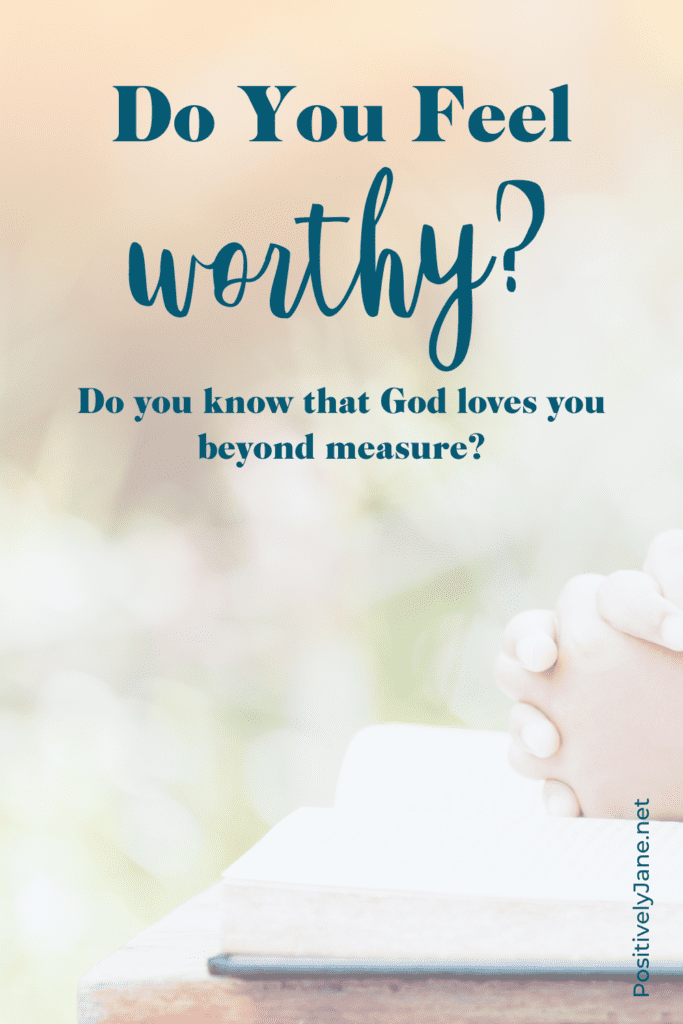 hands sitting on top of a bible praying | do you feel worthy | Positively Jane  