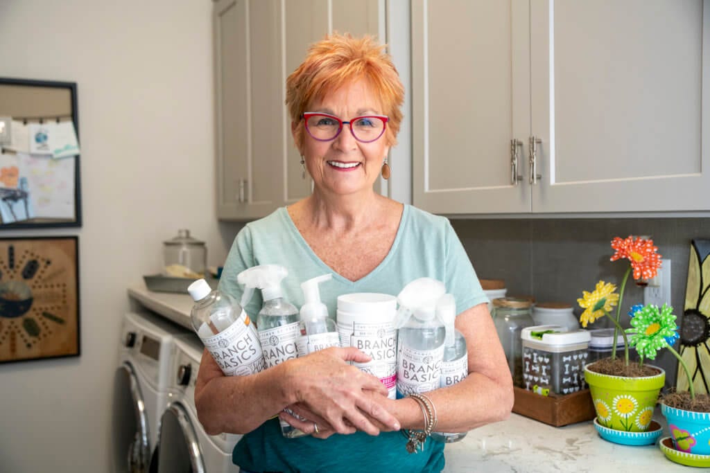 Woman holding Branch Basics Cleaning Supplies