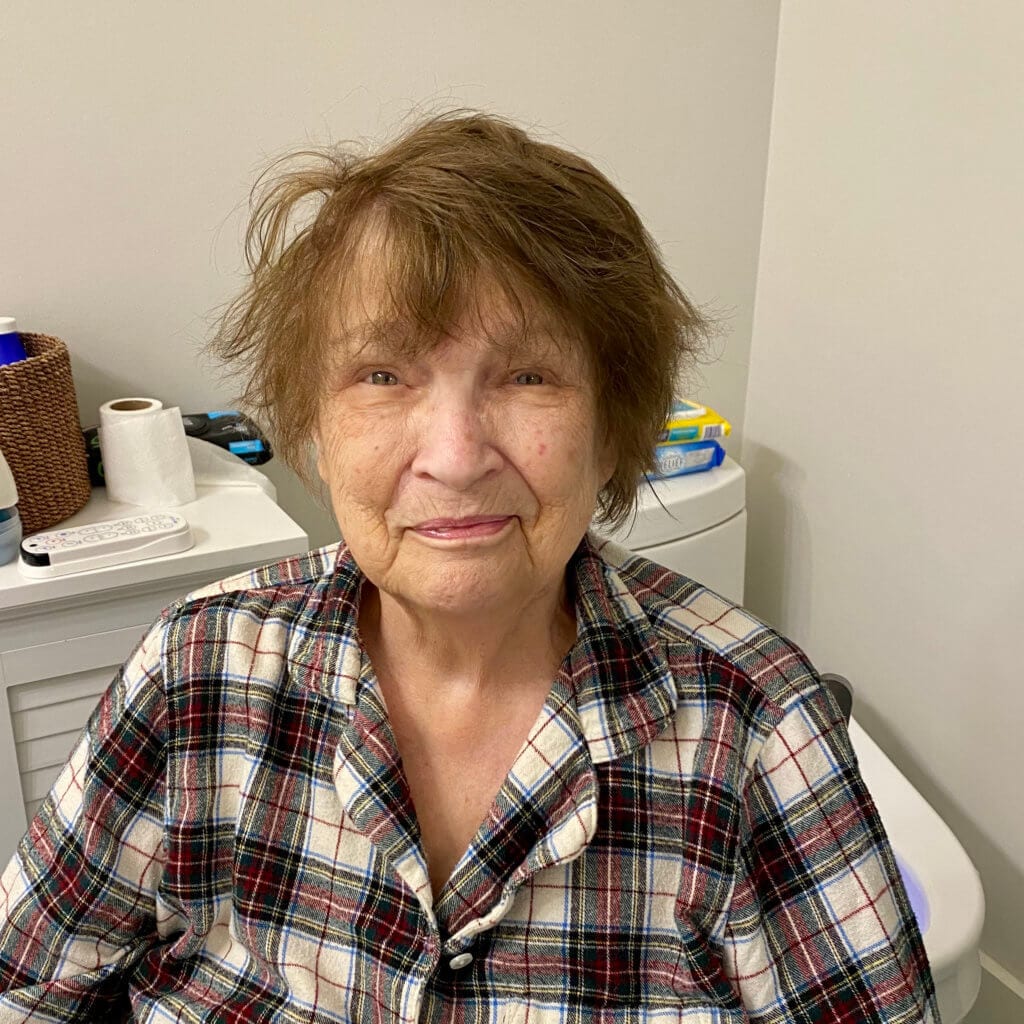 woman sitting in a chair with messy hair waiting for her hair cut