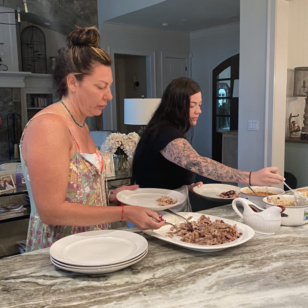 2 girls in a buffet line getting their food | cooking for a crowd | Positively Jane