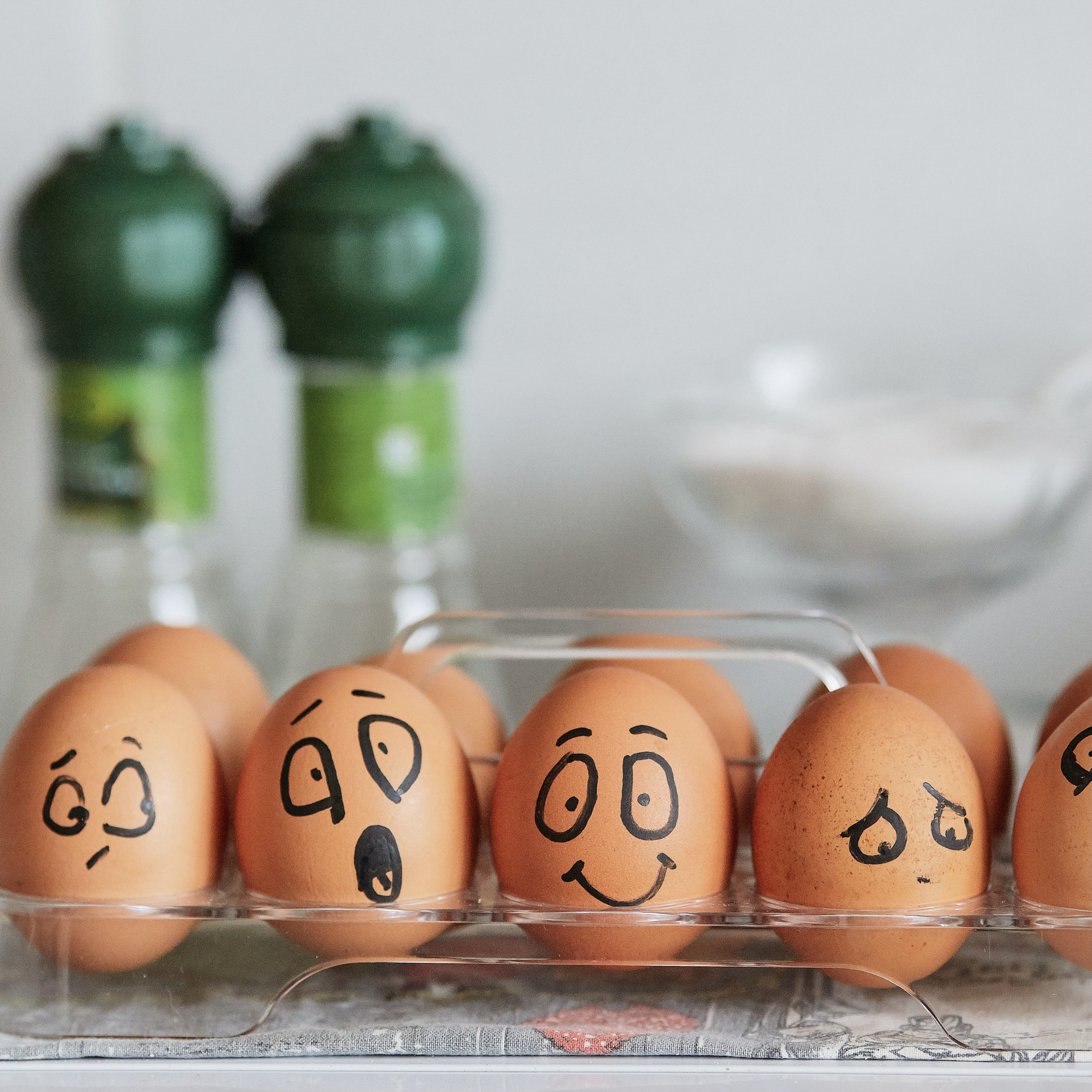 5 brown eggs in a clear container and each one has a different fact sharpied on it. One is sad, one is angry, one is surprised and one is puzzled | where do emotions come from | Positively Jane